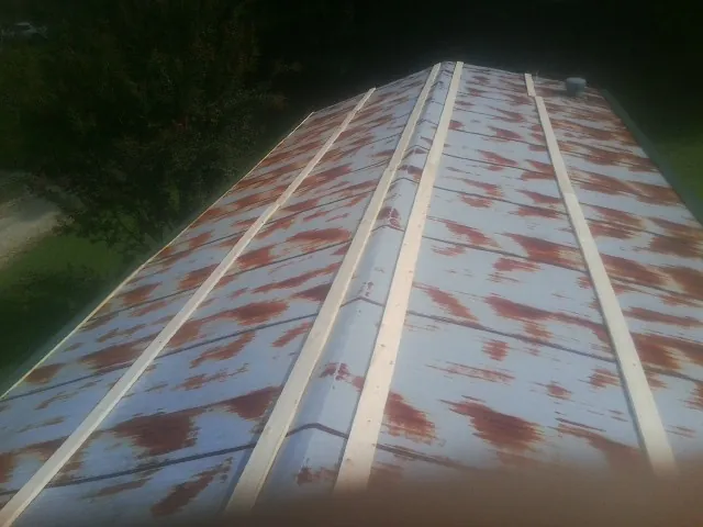 Rusted metal roof panels with new wood purlins before replacement — Storm Damage Roof Repair in Venetia by Roofing Brothers