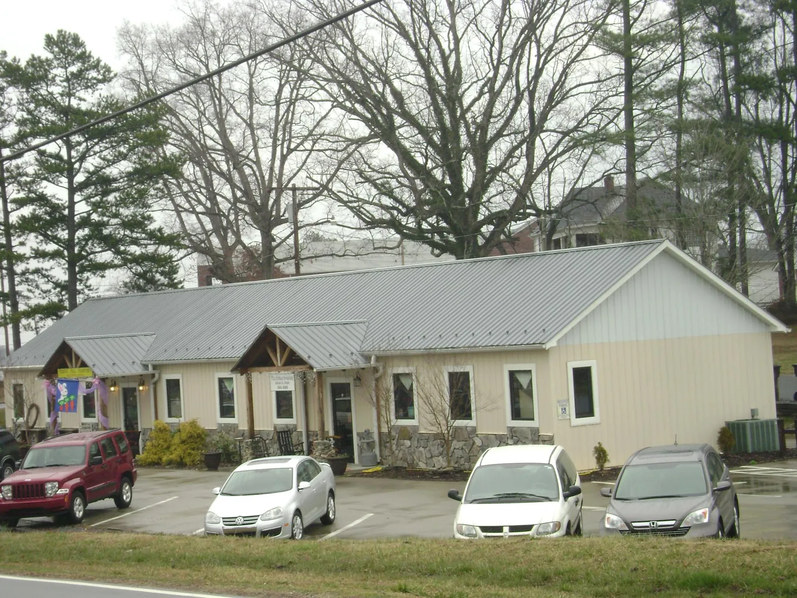 Gray metal roof with timber entry brackets on a small commercial building in Venetia